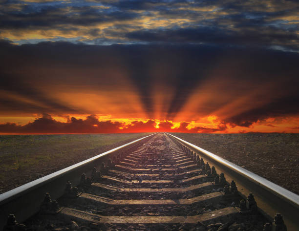 istock rails going away into the fiery red sunset 846112994