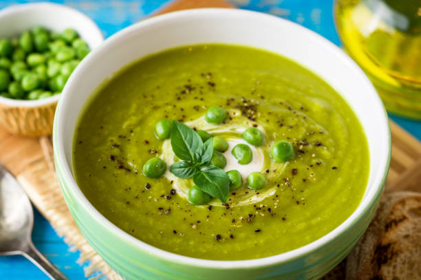 istock Green pea soup in bowl on wooden table 846113278
