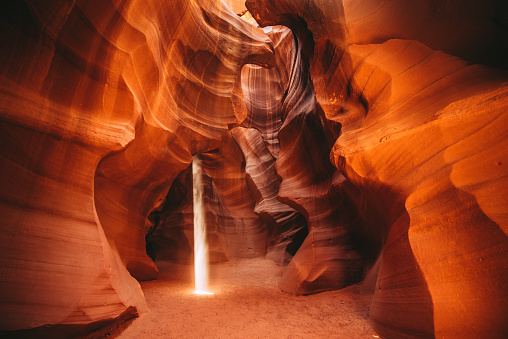 Sunbeams and sand falls in Antelope canyon