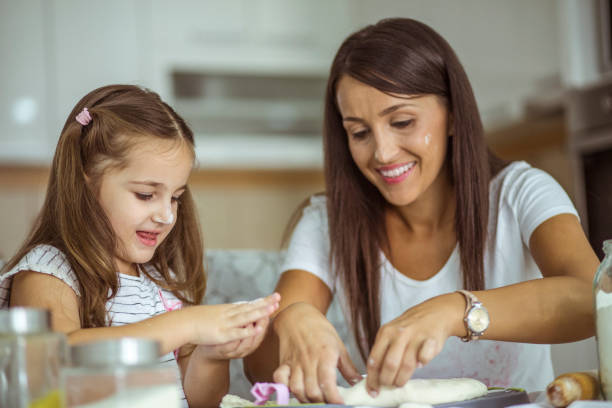 istock Mother and daughter having fun in kitchen 846116842