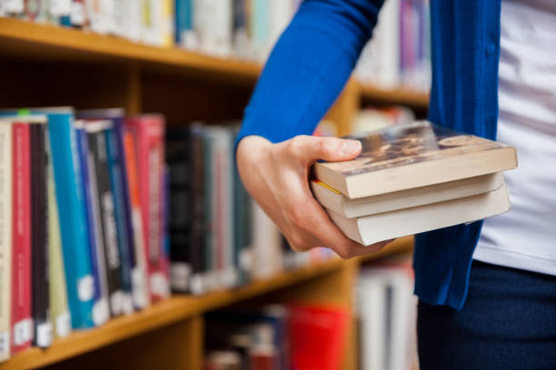 istock Happy female student taking books in the library 846121448