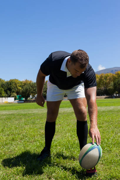 istock player playing rugby on grassy field 846121454