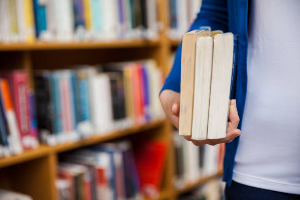istock Happy female student taking books in the library 846121460