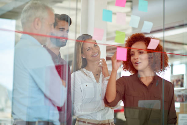 istock Using glass door to make presentation to her colleagues 846123804