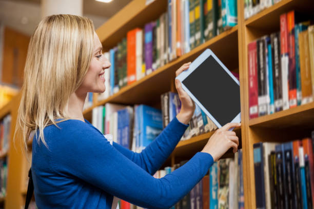 istock Female student tidying a tablet in a bookshelf 846123998