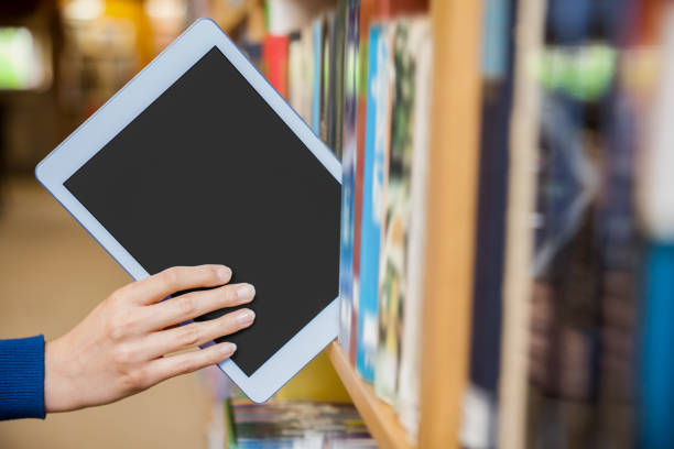 istock Female student tidying a tablet in a bookshelf 846124006