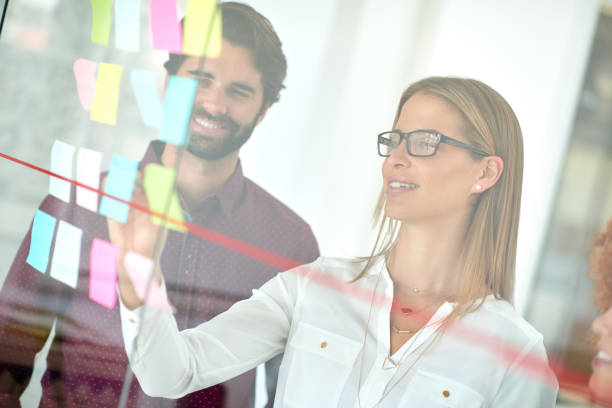 istock Using glass door to make presentation to her colleagues 846126868