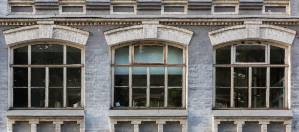 istock Gray facade of a building with three arched windows 846127712