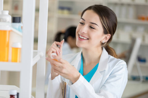 istock Cheerful pharmacist writes something on prescription medication label 846128126