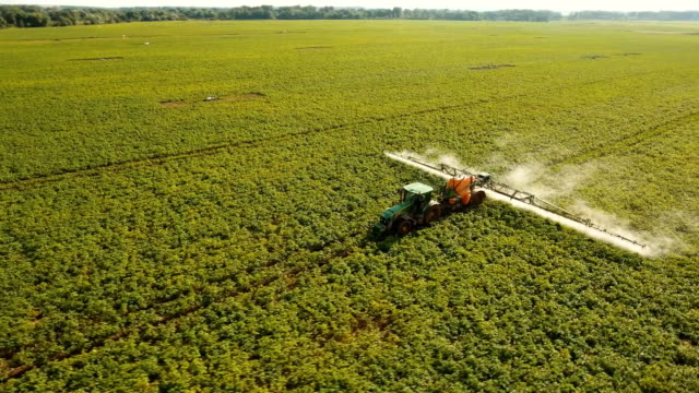 Tractor is spraying fertilizers field