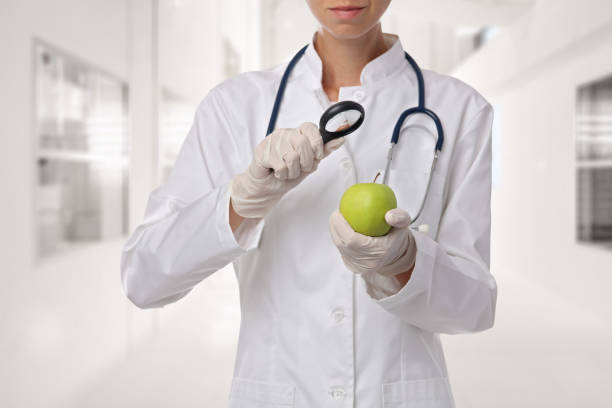 istock Food science, GMO food concept . Scientist inspecting apple sample at laboratory 846134742