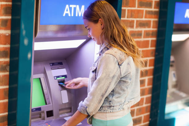 istock Pretty brunette student withdrawing cash 846135576