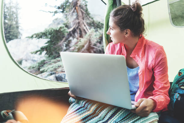 istock Woman tourist inside tent with laptop 846141464