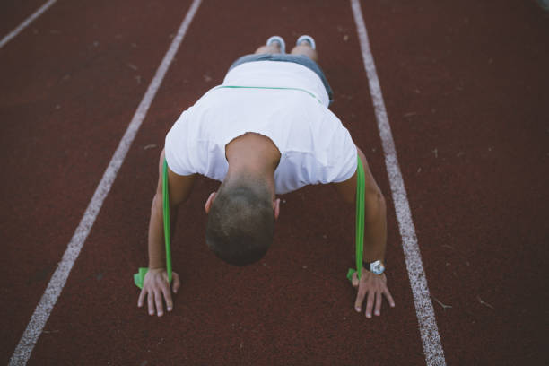 istock Young man doing push-ups on the running track 846144518