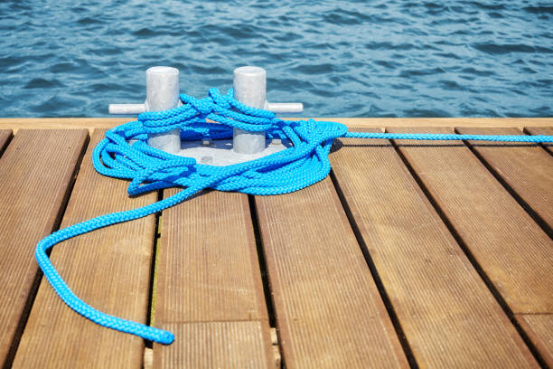 istock Cleat with blue rope on a wooden pier. 846144782