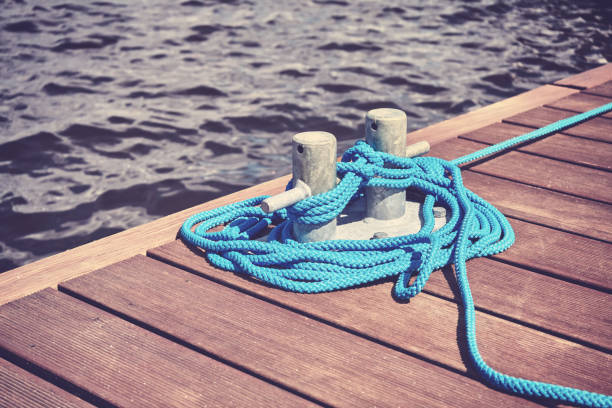 istock Cleat with blue rope on a wooden pier. 846144878