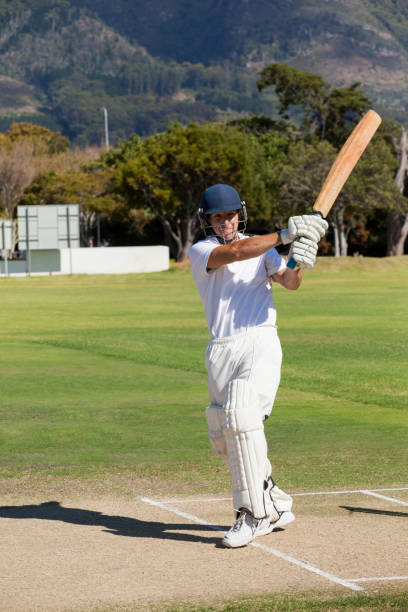 Young batsman playing cricket at field Young batsman playing cricket at field on sunny day batsman stock pictures, royalty-free photos & images