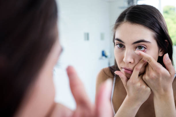istock Brunette putting her contact lens 846147396