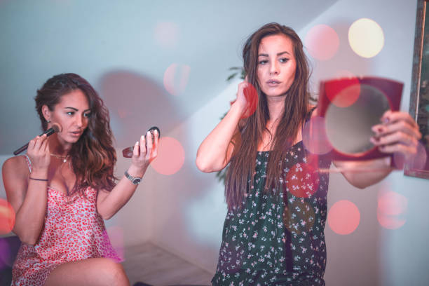 istock Young women applying make-up together 846148646
