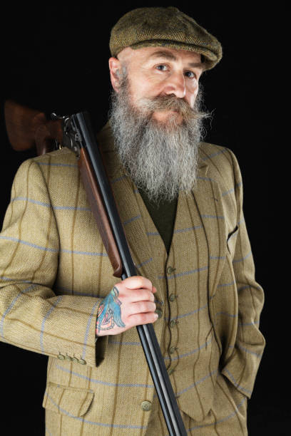 istock Bearded gentleman in his 50s with a shotgun 846155480