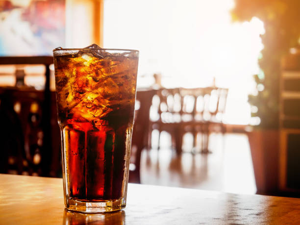 istock Cola glass with ice on wood table in restaurant background 846158220