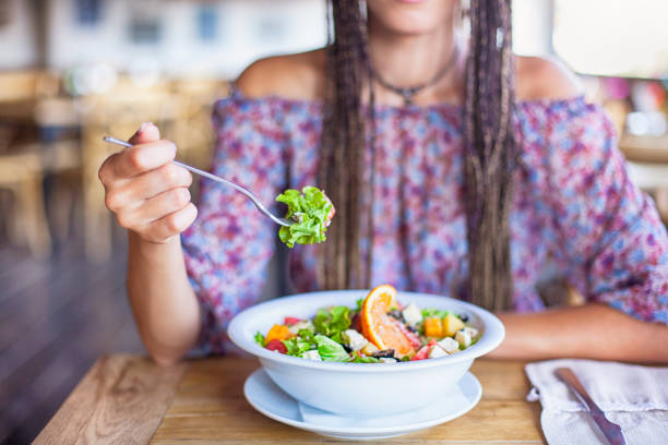 istock Young woman eating salad in restaurant 846158448