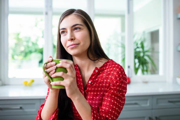 istock Day dreaming brunette holding cup 846163958