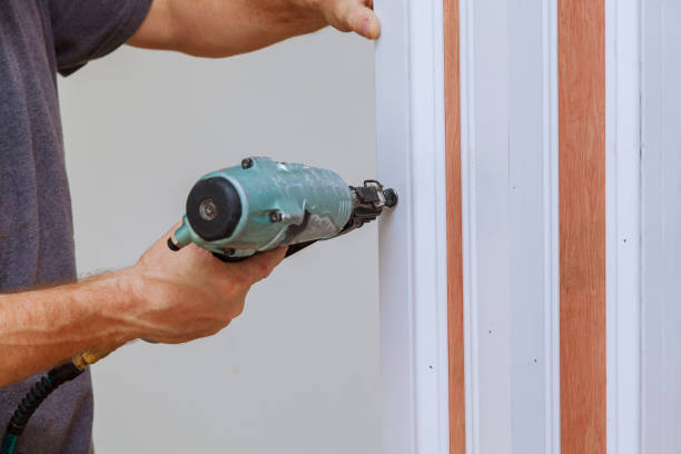 istock Carpenter using a brad nail gun to complete framing trim Air gun for nailing 846164900