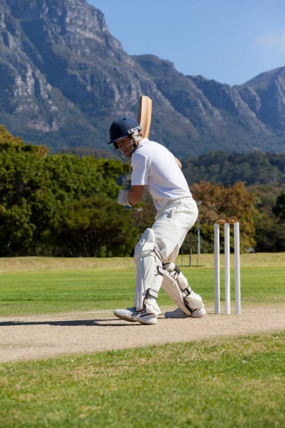 istock Side view of cricket player playing on field 846165378