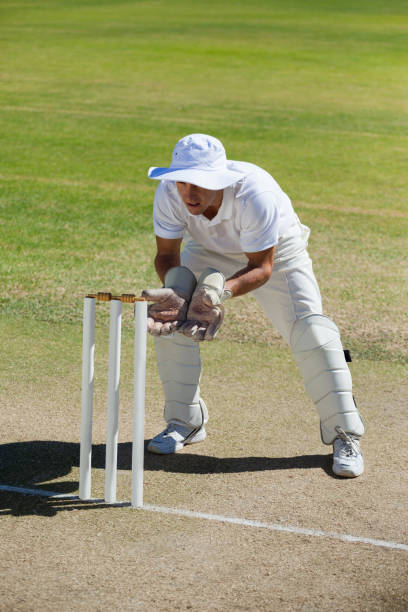 istock Full length of wicketkeeper standing behind stumps on field 846167584