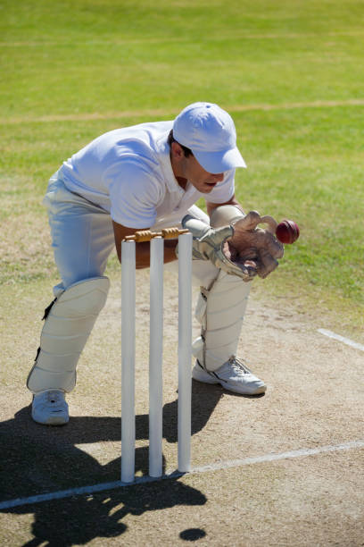 istock Wicketkeeper catching ball behind stumps on field 846167634
