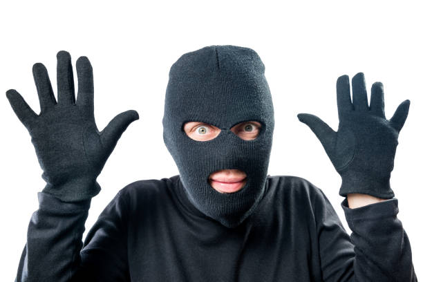 istock Robber in black protective clothing with hands up close-up portrait 846167852