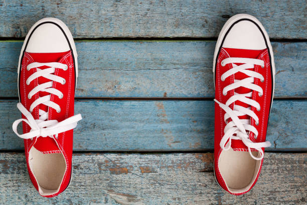 istock Red retro sneakers on a blue wooden background 846171278