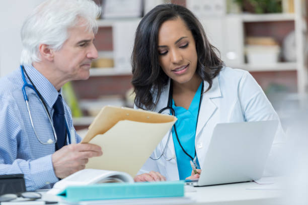 istock Two doctors participate in weekly staff meeting 846171390