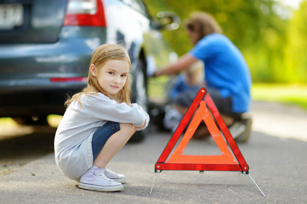 istock Happy family changing a car wheel 846174964