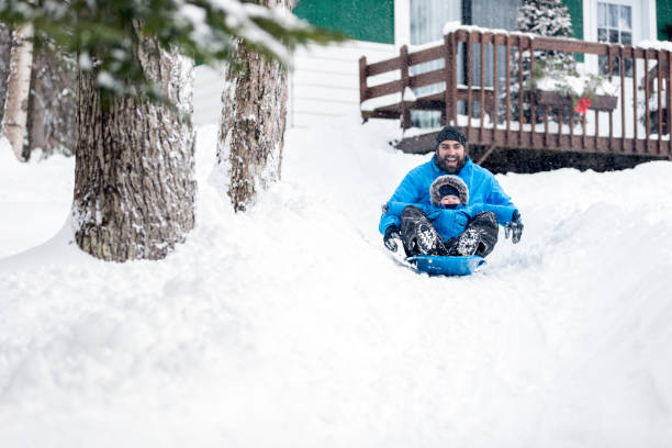 istock Father and Son Sledding on Snow at Christmas 846175174
