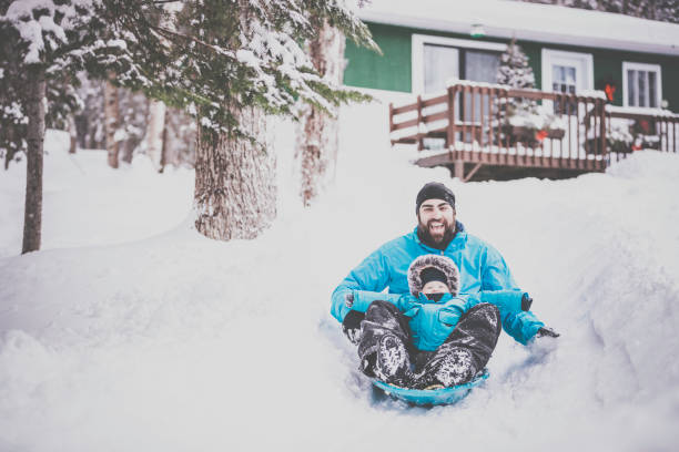 istock Father and Son Sledding on Snow at Christmas 846175176