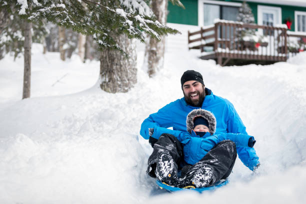 istock Father and Son Sledding on Snow at Christmas 846177560