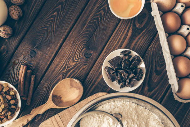 ingredients and tools to make a cake, flour, butter, chocolate, eggs, nuts