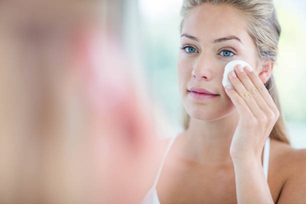 istock Woman wiping her face with cotton pad 846189128