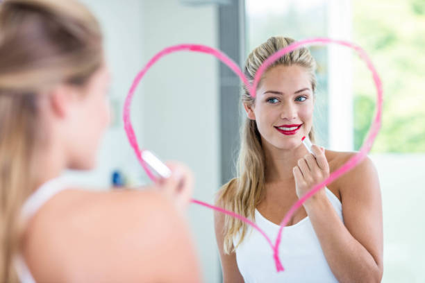istock Woman with lipstick looking in the mirror 846189170
