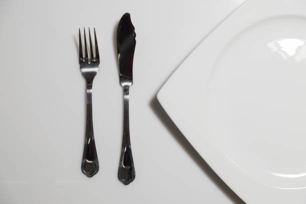 Dish and cutlery Dish and cutlery for eat fish over a white background fish knife stock pictures, royalty-free photos & images