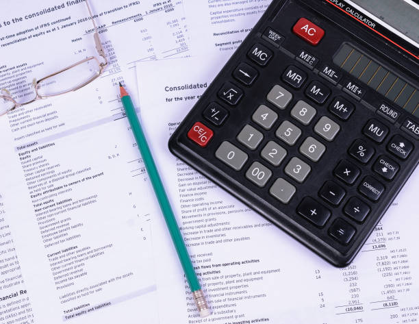 istock Office Desk with papers lying a calculator and a pencil 846192522