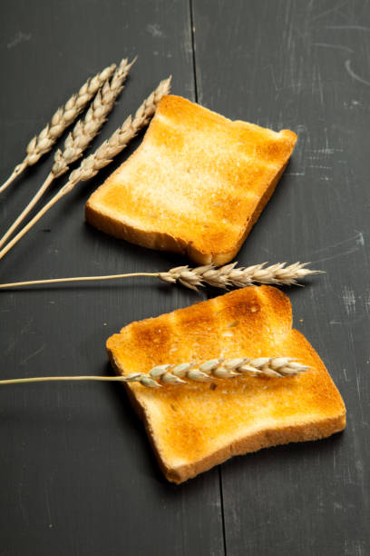 Toast the bread on a black wooden background
