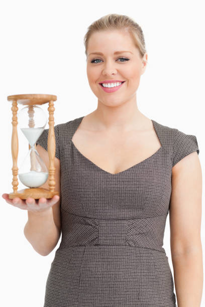 istock Woman smiling while holding a hourglass 846193250