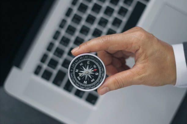 istock Businessman with a compass holding in hand on laptop background 846216996
