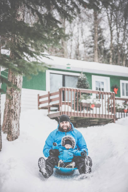 istock Father and Son Sledding on Snow at Christmas 846220816
