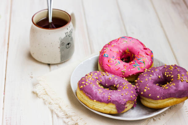 Donuts with Pink Icing Served with Coffee