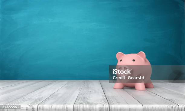 3d Rendering Of A Pink Piggy Bank In Front View Standing On A Wooden Table Stock Photo - Download Image Now