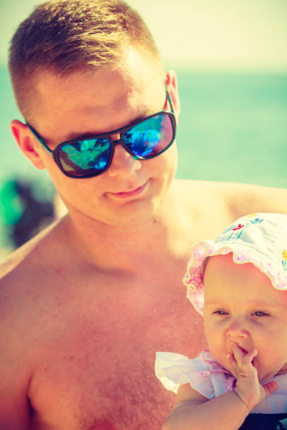 istock Man posing with baby on summer 846222290